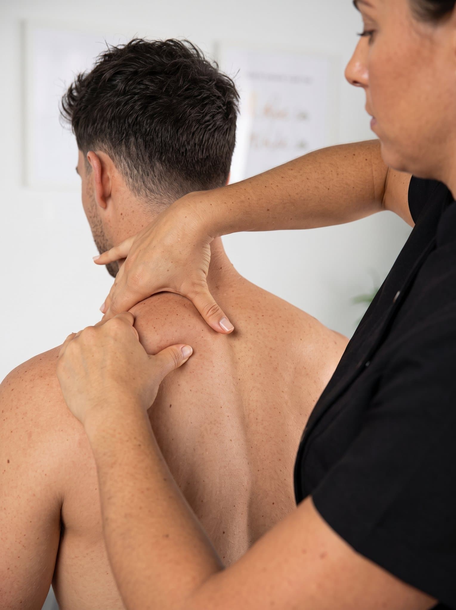 Physical therapist providing hands-on treatment for neck and shoulder pain